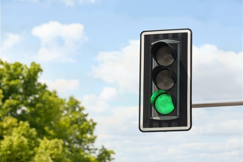A green traffic light signaling go.